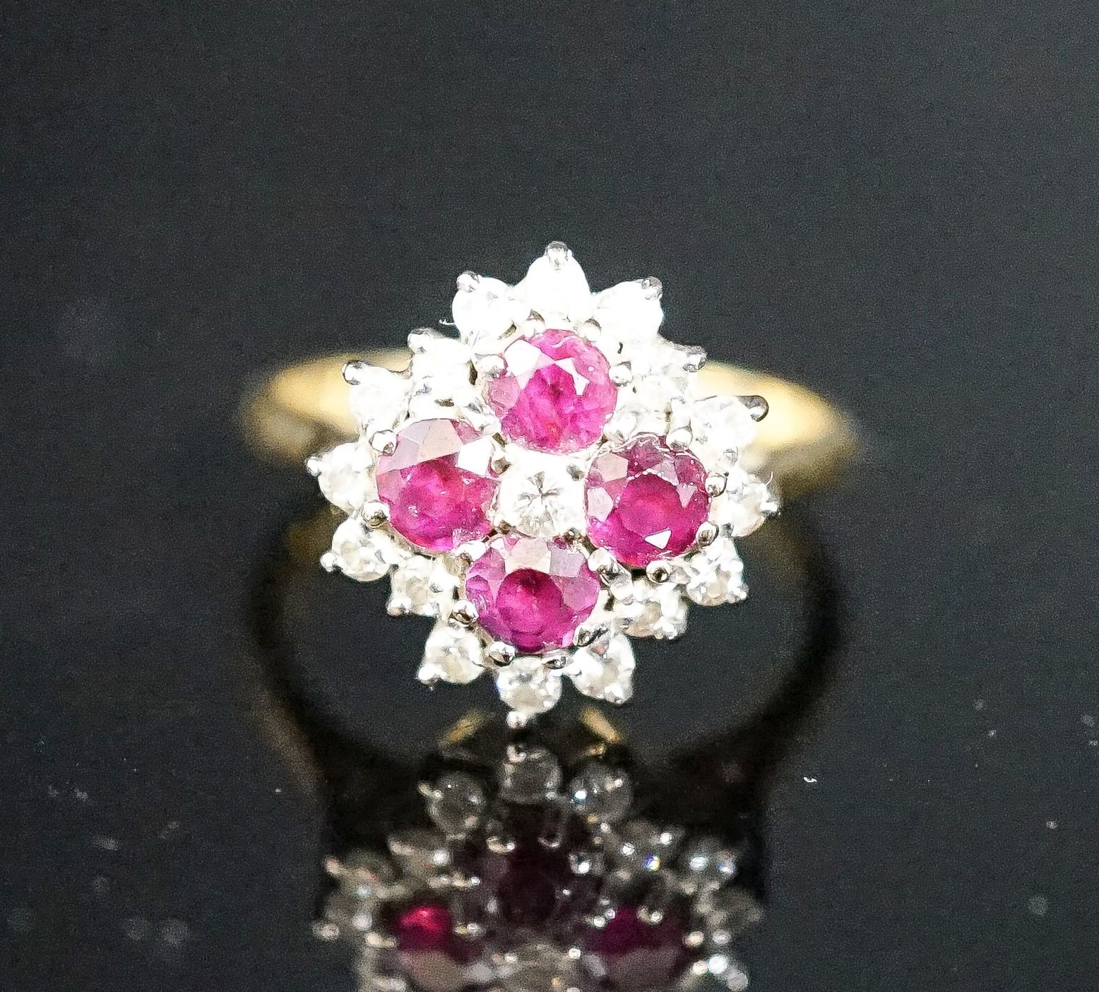 A modern 18ct gold, ruby and diamond cluster ring, size M, gross weight 4.2 grams.